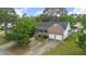 Aerial view of a brick single-Gathering home with a well-manicured lawn and a two car garage at 1732 Bobwhite Ln, Rocky Mount, NC 27804