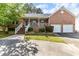 Charming brick home featuring an inviting front porch, manicured landscaping, and a two-car garage at 1732 Bobwhite Ln, Rocky Mount, NC 27804