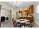 Bright eat-in kitchen with oak cabinets, chandelier and view to the living room at 1732 Bobwhite Ln, Rocky Mount, NC 27804