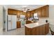Kitchen featuring white appliances, wood cabinets, and ample countertop space at 1732 Bobwhite Ln, Rocky Mount, NC 27804