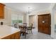 Eat-in kitchen with a classic chandelier, a large window, and a wood hutch at 1732 Bobwhite Ln, Rocky Mount, NC 27804