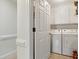 The clean, white laundry room offers upper and lower cabinets, plus a washer and dryer for efficient cleaning at 1732 Bobwhite Ln, Rocky Mount, NC 27804
