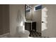 Compact bathroom with modern fixtures, including a toilet, vanity, mirror, and unique tiled flooring at 1802 Pershing Rd, Raleigh, NC 27608