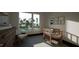 Bright Bedroom with a view of the water and surrounding trees, cute decor, and a cozy chair at 1802 Pershing Rd, Raleigh, NC 27608