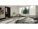 Serene bedroom with a large window, comfortable furnishings, and modern decor at 1802 Pershing Rd, Raleigh, NC 27608