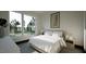 Bright bedroom featuring large windows with a picturesque view, a plush bed, and minimalist decor at 1802 Pershing Rd, Raleigh, NC 27608