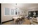 Bright dining area features a modern light fixture, stylish table setting, and hardwood floors at 1802 Pershing Rd, Raleigh, NC 27608