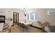 Modern dining room with a large table, seating for six, and plenty of natural light from the windows at 1802 Pershing Rd, Raleigh, NC 27608