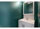 Stylish powder room featuring a modern vanity, large mirror, and dark teal walls at 1910 Falls Landing Dr, Raleigh, NC 27614