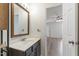 Bathroom vanity sink with hardwood cabinets and a view into the bedroom at 1910 Falls Landing Dr, Raleigh, NC 27614