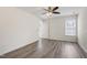This bedroom is bright and spacious, with hardwood flooring and natural light from the windows at 1910 Falls Landing Dr, Raleigh, NC 27614