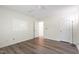 An interior bedroom with wood flooring and a door for closet or ensuite bathroom at 1910 Falls Landing Dr, Raleigh, NC 27614