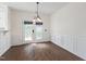 Bright dining area with hardwood floors, a stylish chandelier, and a view of the backyard at 1910 Falls Landing Dr, Raleigh, NC 27614