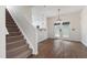 Open-concept dining area with hardwood floors, a modern chandelier, and access to the backyard at 1910 Falls Landing Dr, Raleigh, NC 27614
