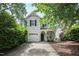 Charming two-story home with a well-manicured lawn and attached garage, framed by mature trees at 1910 Falls Landing Dr, Raleigh, NC 27614