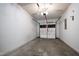 Interior view of garage with white painted walls and a closed door at 1910 Falls Landing Dr, Raleigh, NC 27614