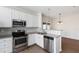 Modern kitchen with stainless steel appliances, granite countertops, and white tile backsplash at 1910 Falls Landing Dr, Raleigh, NC 27614