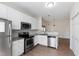 Bright kitchen features stainless steel appliances, granite countertops and a white backsplash at 1910 Falls Landing Dr, Raleigh, NC 27614
