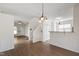 Open-concept living space with hardwood floors, a staircase, and access to the dining area and kitchen at 1910 Falls Landing Dr, Raleigh, NC 27614
