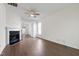Bright living room with hardwood floors, a ceiling fan, and a cozy fireplace at 1910 Falls Landing Dr, Raleigh, NC 27614