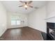Bright living room with hardwood floors, a ceiling fan, and a cozy fireplace at 1910 Falls Landing Dr, Raleigh, NC 27614
