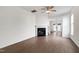 Bright living room with hardwood floors, a ceiling fan, and a cozy fireplace at 1910 Falls Landing Dr, Raleigh, NC 27614