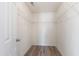 This walk-in closet has hardwood flooring and shelves for storage at 1910 Falls Landing Dr, Raleigh, NC 27614