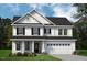 Charming two-story home with black shutters and a two-car garage, surrounded by a well-manicured lawn at 1913 Ballard Rd # 193, Fuquay Varina, NC 27526