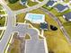 Aerial view of community pool with lounge seating, black metal fence, playground and ample parking at 1913 Ballard Rd # 193, Fuquay Varina, NC 27526