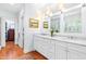 Bright bathroom with dual sinks, marble countertops, and a large framed mirror at 2111 Woodland Ave, Raleigh, NC 27608