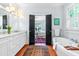 Bright bathroom featuring a soaking tub, dual vanity, and modern fixtures at 2111 Woodland Ave, Raleigh, NC 27608