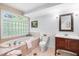 Bathroom with a large soaking tub, tiled walls, and a wooden vanity at 2111 Woodland Ave, Raleigh, NC 27608