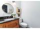 The cozy bathroom features a vanity with granite countertop and updated fixtures at 2111 Woodland Ave, Raleigh, NC 27608