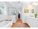 Bathroom with soaking tub, glass shower, marble countertops, and walk-in closet at 2111 Woodland Ave, Raleigh, NC 27608