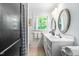 Bathroom with double vanity, tiled floors, and shower at 2111 Woodland Ave, Raleigh, NC 27608