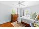 Bedroom with a four-poster bed, hardwood floors, and windows with natural light at 2111 Woodland Ave, Raleigh, NC 27608