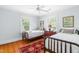 Bedroom with two twin beds, hardwood floors, and a ceiling fan at 2111 Woodland Ave, Raleigh, NC 27608