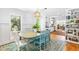 This dining room has large windows and is open to the kitchen, making it the perfect space for entertaining at 2111 Woodland Ave, Raleigh, NC 27608