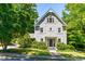 Charming two-story home featuring light gray siding, well-maintained landscaping, and a welcoming front porch at 2111 Woodland Ave, Raleigh, NC 27608