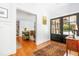 Inviting foyer featuring hardwood floors, a vintage rug, and entry to an adjacent room at 2111 Woodland Ave, Raleigh, NC 27608