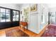 Traditional foyer with hardwood floors, black French doors, and light-filled windows at 2111 Woodland Ave, Raleigh, NC 27608