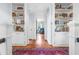 Hallway with built-in bookshelves and hardwood floors at 2111 Woodland Ave, Raleigh, NC 27608
