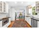 Modern kitchen with white cabinets, black countertops, stainless steel appliances, and hardwood floors at 2111 Woodland Ave, Raleigh, NC 27608