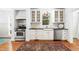 This kitchen boasts white cabinets, stainless steel appliances, and a view of the yard through the window at 2111 Woodland Ave, Raleigh, NC 27608