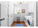 Bright laundry room with washer, dryer, cabinets, and charming decor at 2111 Woodland Ave, Raleigh, NC 27608