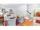 Bright living room featuring hardwood floors, neutral-toned furniture, and staircase access to upper floor at 2111 Woodland Ave, Raleigh, NC 27608