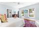 Relaxing bedroom with flat screen TV, hardwood floors and ensuite bath at 2111 Woodland Ave, Raleigh, NC 27608