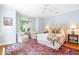 Comfortable bedroom with hardwood floors, area rug and sitting area with chairs at 2111 Woodland Ave, Raleigh, NC 27608