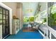 Relaxing screened porch with comfortable seating and view to the outside at 2111 Woodland Ave, Raleigh, NC 27608