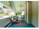 Inviting screened porch with seating, ceiling fan, and serene outdoor views at 2111 Woodland Ave, Raleigh, NC 27608